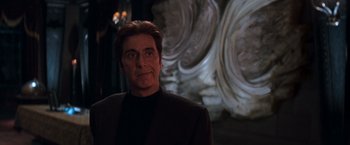Movie still from “The Devil's Advocate” (1997), directed by Taylor Hackford – A person wearing a suit; Medium shot, Low angle