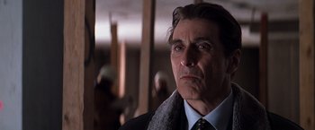 Movie still from “The Devil's Advocate” (1997), directed by Taylor Hackford – A person wearing a suit and tie; Close Up shot, Low angle