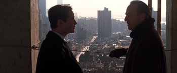Movie still from “The Devil's Advocate” (1997), directed by Taylor Hackford – A man standing on a ledge looking out over a city; Medium shot, Low angle