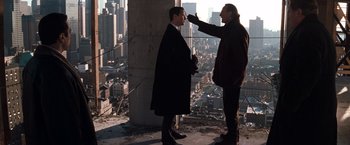 Movie still from “The Devil's Advocate” (1997), directed by Taylor Hackford – Two men standing next to each other on a building; Medium shot, Over the shoulder angle