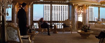 Movie still from “The Devil's Advocate” (1997), directed by Taylor Hackford – A man sitting in a chair in front of a large window; Wide shot, Low angle