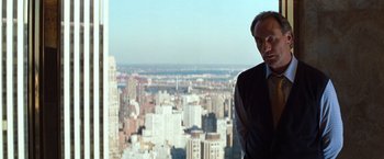 Movie still from “The Devil's Advocate” (1997), directed by Taylor Hackford – A man standing in front of a city skyline; Medium shot, Over the shoulder angle