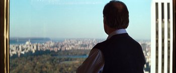 Movie still from “The Devil's Advocate” (1997), directed by Taylor Hackford – A man looking out over a city from a hill; Medium shot, Over the shoulder angle