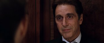 Movie still from “The Devil's Advocate” (1997), directed by Taylor Hackford – A person wearing a suit and tie; Close Up shot, Over the shoulder angle