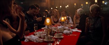 Movie still from “The Devil's Advocate” (1997), directed by Taylor Hackford – A group of people sitting around a table; Wide shot, High angle