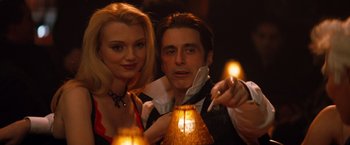 Movie still from “The Devil's Advocate” (1997), directed by Taylor Hackford – A man and a woman posing for a picture; Medium shot, Low angle