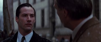 Movie still from “The Devil's Advocate” (1997), directed by Taylor Hackford – A man and a woman are standing outside in the rain; Close Up shot, Over the shoulder angle