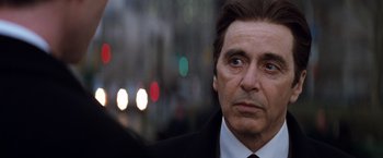 Movie still from “The Devil's Advocate” (1997), directed by Taylor Hackford – A person wearing a suit and tie; Close Up shot, Over the shoulder angle