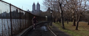 Movie still from “The Devil's Advocate” (1997), directed by Taylor Hackford – A man running down the side of a road; Wide shot, High angle