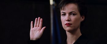 Movie still from “The Devil's Advocate” (1997), directed by Taylor Hackford – A woman is holding her hand up in the air; Close Up shot, Low angle
