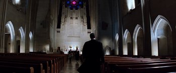 Movie still from “The Devil's Advocate” (1997), directed by Taylor Hackford – A man and a woman walking through a church; Extreme Wide shot, Low angle