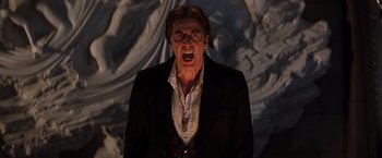 Movie still from “The Devil's Advocate” (1997), directed by Taylor Hackford – A man with a beard and a jacket on; Close Up shot, Low angle