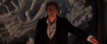 Movie still from “The Devil's Advocate” (1997), directed by Taylor Hackford – A man in a black jacket and a white shirt; Close Up shot, Low angle