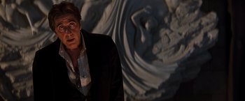 Movie still from “The Devil's Advocate” (1997), directed by Taylor Hackford – A man standing in front of a statue of a woman; Close Up shot, Low angle