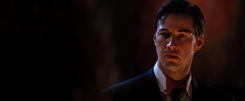 Movie still from “The Devil's Advocate” (1997), directed by Taylor Hackford – A person wearing a suit and tie; Close Up shot, Low angle