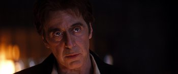 Movie still from “The Devil's Advocate” (1997), directed by Taylor Hackford – A person looking at the camera; Close Up shot, Over the shoulder angle