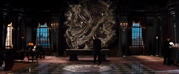 Movie still from “The Devil's Advocate” (1997), directed by Taylor Hackford – A man standing in front of a large sculpture; Wide shot, High angle