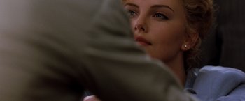 Movie still from “The Devil's Advocate” (1997), directed by Taylor Hackford – A woman's face as she sits in bed; Close Up shot, Over the shoulder angle