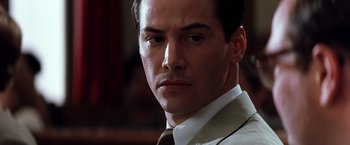 Movie still from “The Devil's Advocate” (1997), directed by Taylor Hackford – A person wearing a suit and tie; Close Up shot, Low angle
