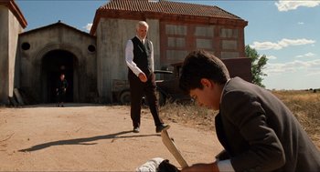Movie still from “The Devil's Backbone” (2001), directed by Guillermo del Toro – A man and a young boy standing on a dirt road; Wide shot, Low angle
