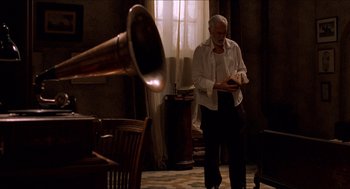 Movie still from “The Devil's Backbone” (2001), directed by Guillermo del Toro – An older man standing in front of a window; Medium shot, Low angle