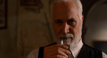 Movie still from “The Devil's Backbone” (2001), directed by Guillermo del Toro – An older man drinking a glass of water; Close Up shot, Low angle