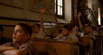 Movie still from “The Devil's Backbone” (2001), directed by Guillermo del Toro – A group of children sitting at a desk in front of a map; Medium shot, High angle