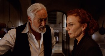 Movie still from “The Devil's Backbone” (2001), directed by Guillermo del Toro – An older man and a younger woman standing next to each other; Close Up shot, Over the shoulder angle