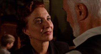 Movie still from “The Devil's Backbone” (2001), directed by Guillermo del Toro – An older woman is looking into the camera; Close Up shot, Over the shoulder angle