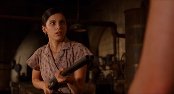 Movie still from “The Devil's Backbone” (2001), directed by Guillermo del Toro – A woman holding a gun in a room; Close Up shot, Over the shoulder angle
