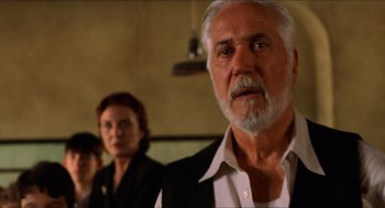 Movie still from “The Devil's Backbone” (2001), directed by Guillermo del Toro – An older man and a younger woman standing in front of a mirror; Close Up shot, Low angle