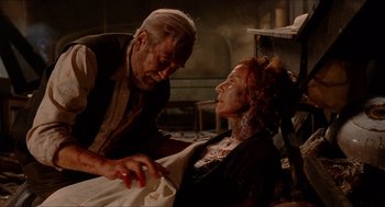 Movie still from “The Devil's Backbone” (2001), directed by Guillermo del Toro – An older man and a younger woman in a room; Medium shot, Over the shoulder angle