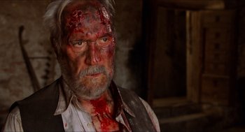 Movie still from “The Devil's Backbone” (2001), directed by Guillermo del Toro – A person with blood all over his face; Close Up shot, Over the shoulder angle