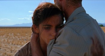 Movie still from “The Devil's Backbone” (2001), directed by Guillermo del Toro – A man and a woman hugging in a field; Close Up shot, Over the shoulder angle