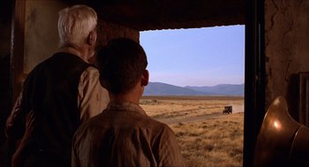 Movie still from “The Devil's Backbone” (2001), directed by Guillermo del Toro – Two men looking out a window at a field; Wide shot, Over the shoulder angle