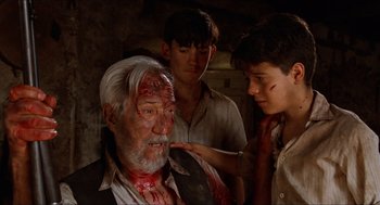 Movie still from “The Devil's Backbone” (2001), directed by Guillermo del Toro – A man with blood all over his face; Close Up shot, Over the shoulder angle