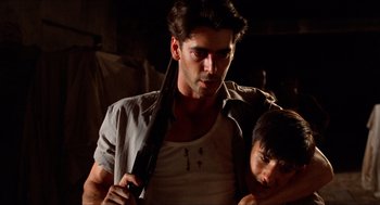 Movie still from “The Devil's Backbone” (2001), directed by Guillermo del Toro – A man holding a knife with a child in it; Close Up shot, Over the shoulder angle