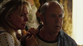 Movie still from “The Devil's Rejects” (2005), directed by Rob Zombie – An older man and a younger woman looking at each other; Close Up shot, Over the shoulder angle