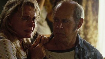 Movie still from “The Devil's Rejects” (2005), directed by Rob Zombie – An older man and a younger woman are looking at each other; Close Up shot, Over the shoulder angle