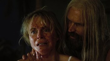 Movie still from “The Devil's Rejects” (2005), directed by Rob Zombie – A man and a woman with bruises on their faces; Close Up shot, Low angle