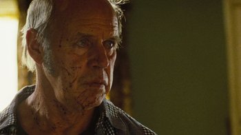 Movie still from “The Devil's Rejects” (2005), directed by Rob Zombie – An old man with a lot of dirt all over his face; Close Up shot, Low angle