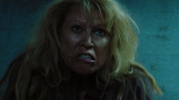 Movie still from “The Devil's Rejects” (2005), directed by Rob Zombie – A woman with blonde hair and blue eyes; Close Up shot, Low angle