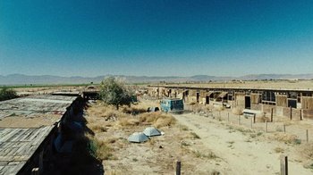 Movie still from “The Devil's Rejects” (2005), directed by Rob Zombie – An old van parked in the middle of a field; Extreme Wide shot, High angle