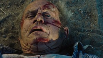 Movie still from “The Devil's Rejects” (2005), directed by Rob Zombie – An old man with blood all over his face; Close Up shot, Overhead angle