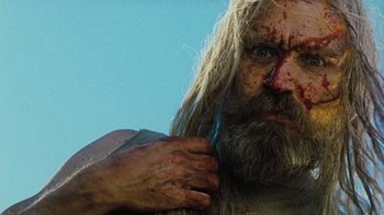 Movie still from “The Devil's Rejects” (2005), directed by Rob Zombie – A person with long hair and a beard; Close Up shot, Low angle