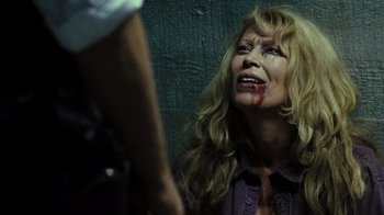 Movie still from “The Devil's Rejects” (2005), directed by Rob Zombie – A woman with blood all over her face; Close Up shot, Over the shoulder angle