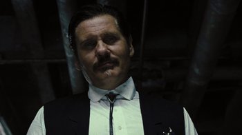 Movie still from “The Devil's Rejects” (2005), directed by Rob Zombie – A person wearing a suit and tie; Close Up shot, Low angle