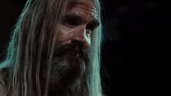 Movie still from “The Devil's Rejects” (2005), directed by Rob Zombie – A man with long hair and a long beard; Close Up shot, Over the shoulder angle