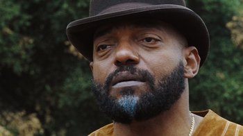 Movie still from “The Devil's Rejects” (2005), directed by Rob Zombie – A person wearing a hat; Close Up shot, Low angle