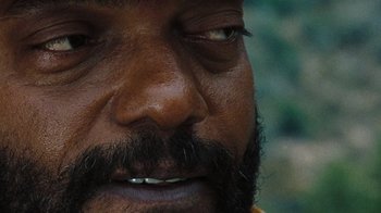 Movie still from “The Devil's Rejects” (2005), directed by Rob Zombie – A man with a beard and mustache; Extreme Close Up shot, High angle